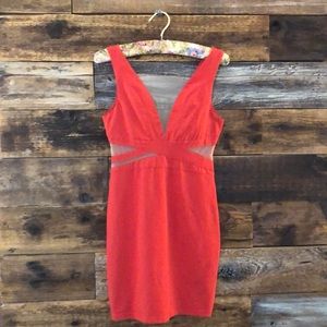 Dress with mesh cut outs.  Coral in Color.
